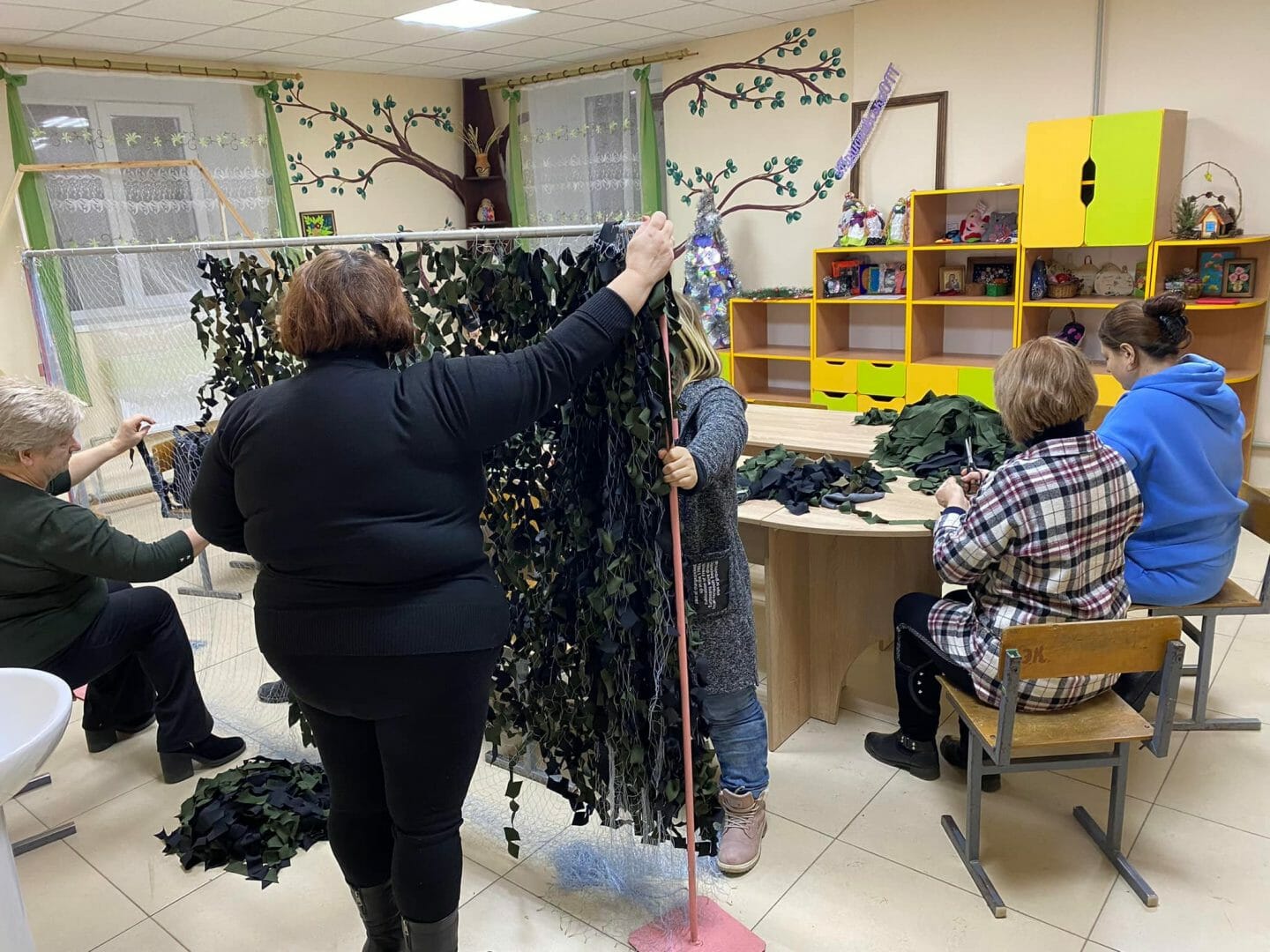 Employees of education institutions weave camouflage nets 