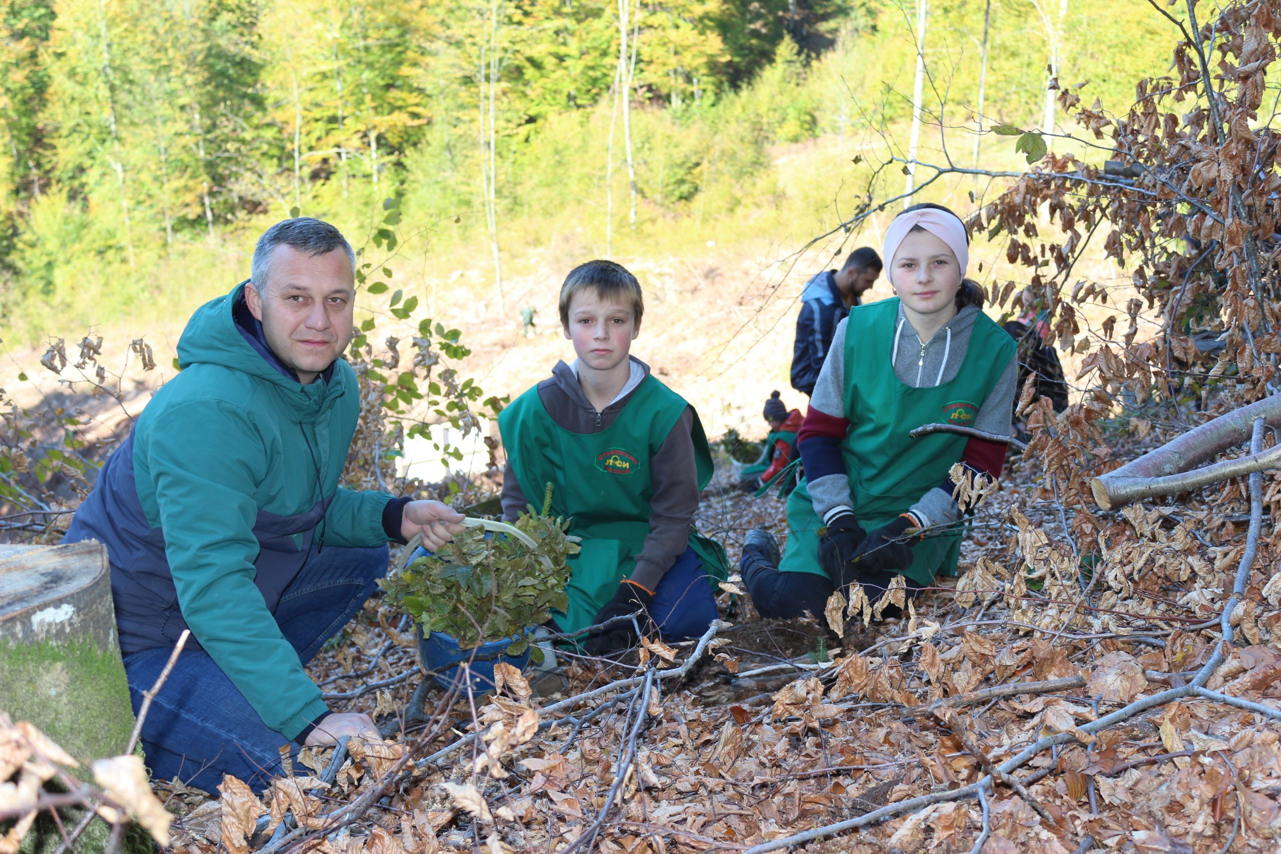 Forest restoration works, children together with village head Denys Kahanets