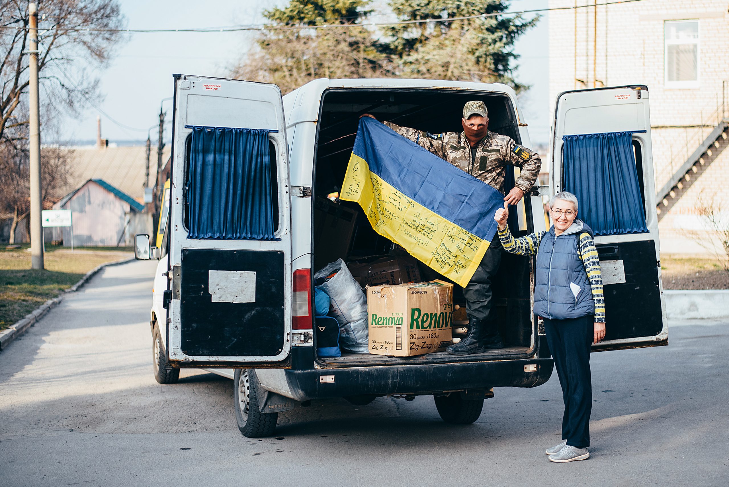 Maryna Yudina, Community Deputy Head, head of the Humanitarian Hub of the Shyroke community, hands over aid to a soldier of the Territorial Defence Forces, April 2022, photo by Oleksandr Ivchyk