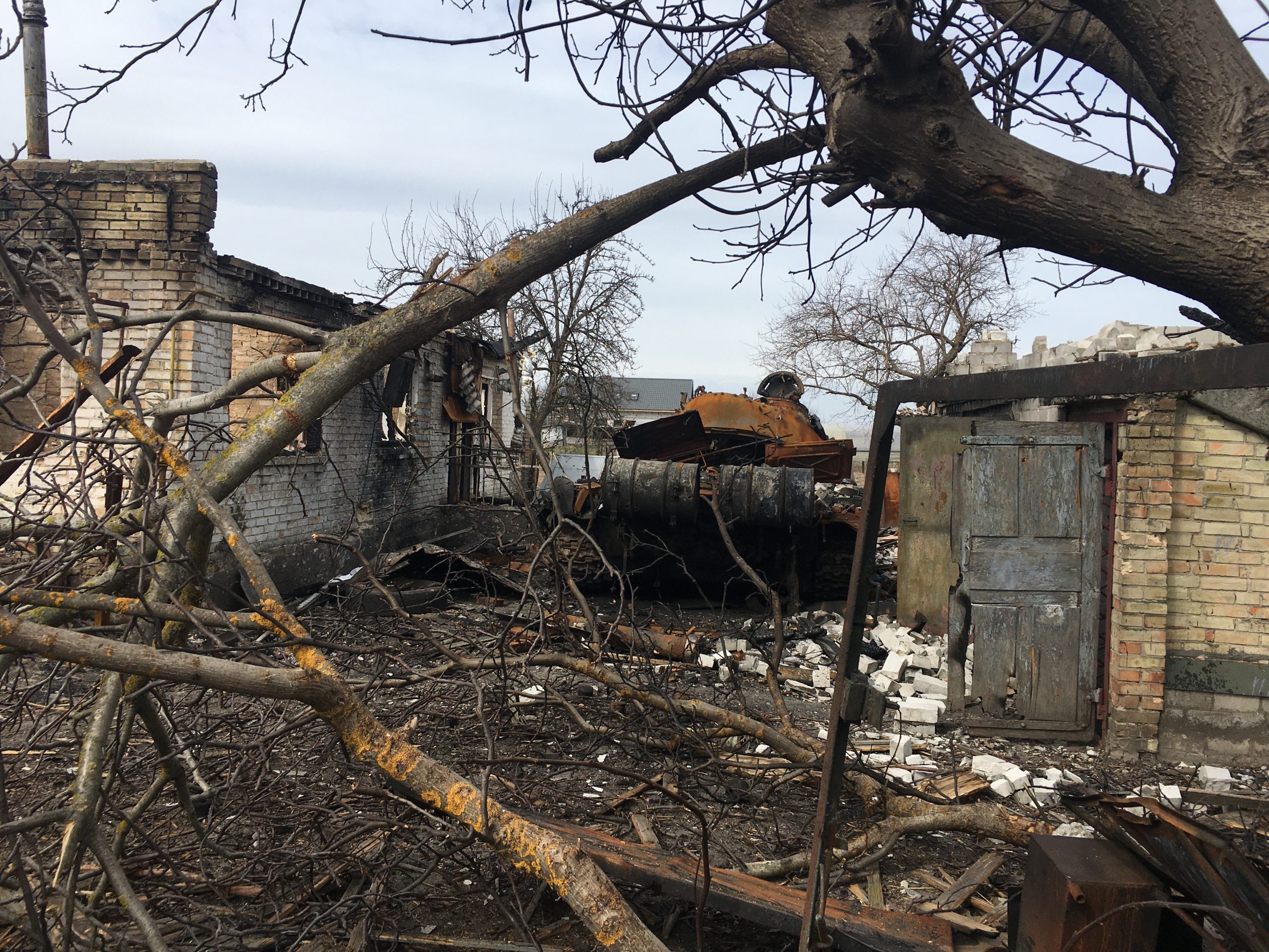 Destroyed residential building in the settlement of Velyka Dymerka (with an enemy tank in the yard)